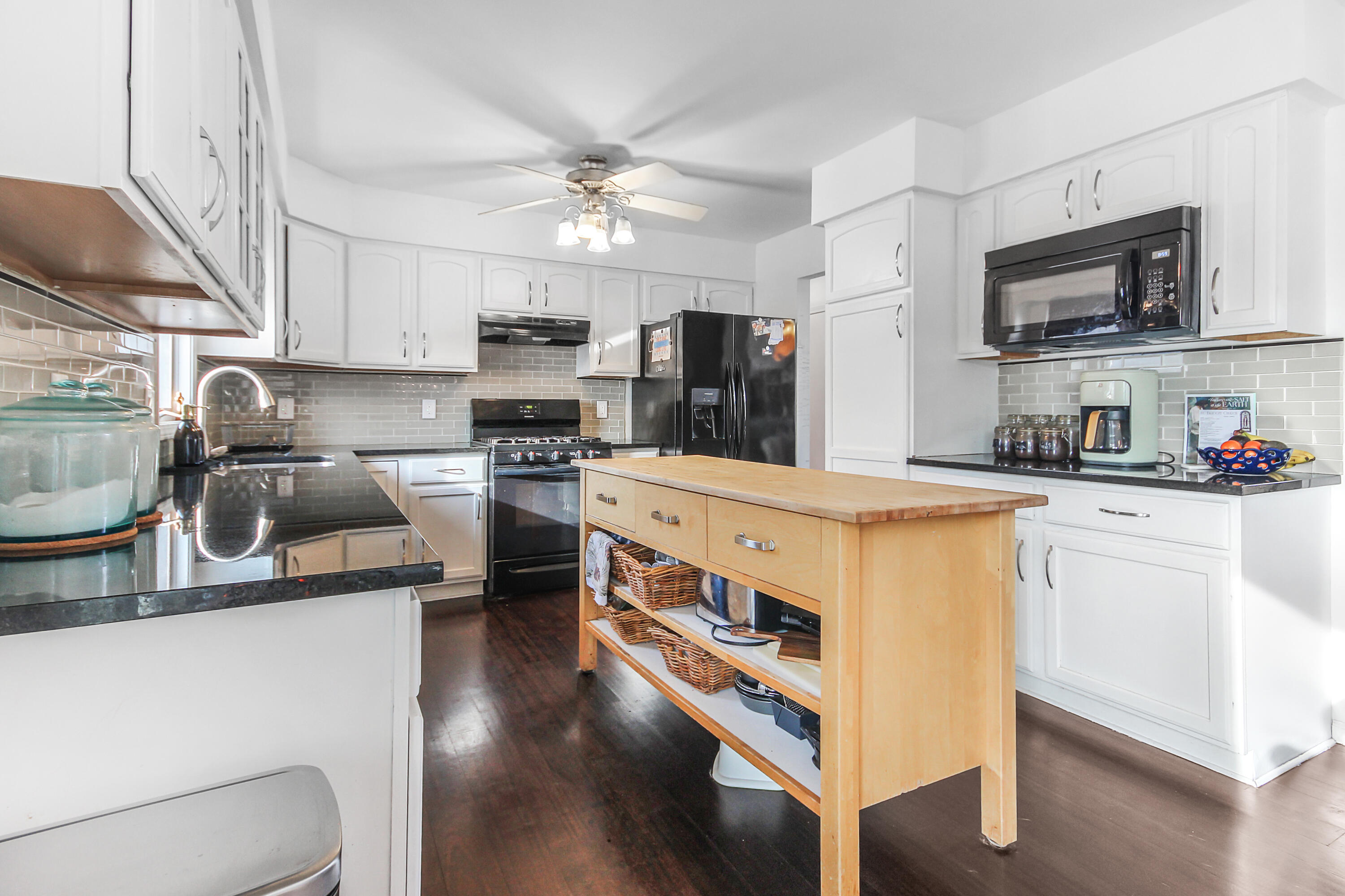 1691 Ruby Court Hobart, IN 46342 - Photo 8 of 27 a kitchen with stainless steel appliances a sink a stove a microwave a refrigerator cabinets and a counter space