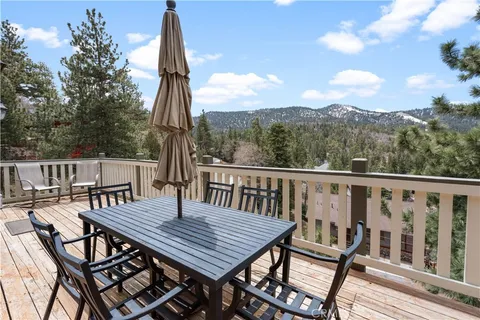 a view of a wooden chairs and table on the deck