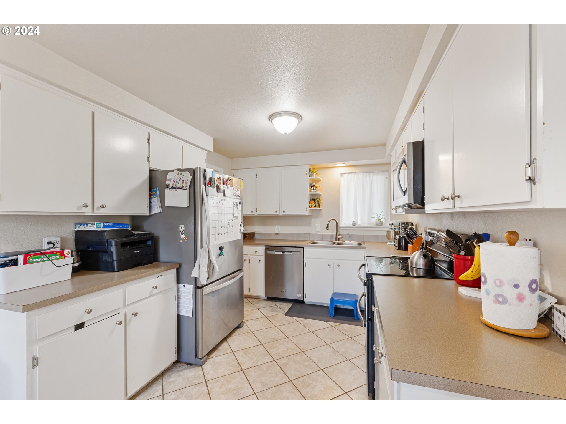 3851 Alcona Street Springfield, OR 97478 - Photo 6 of 22 a kitchen with white cabinets and white appliances