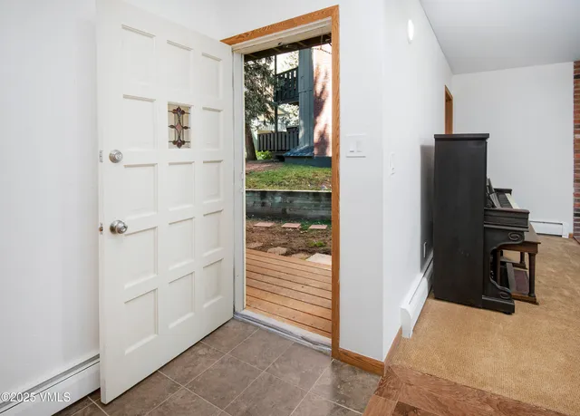 a view of a hallway to rooms and stairs