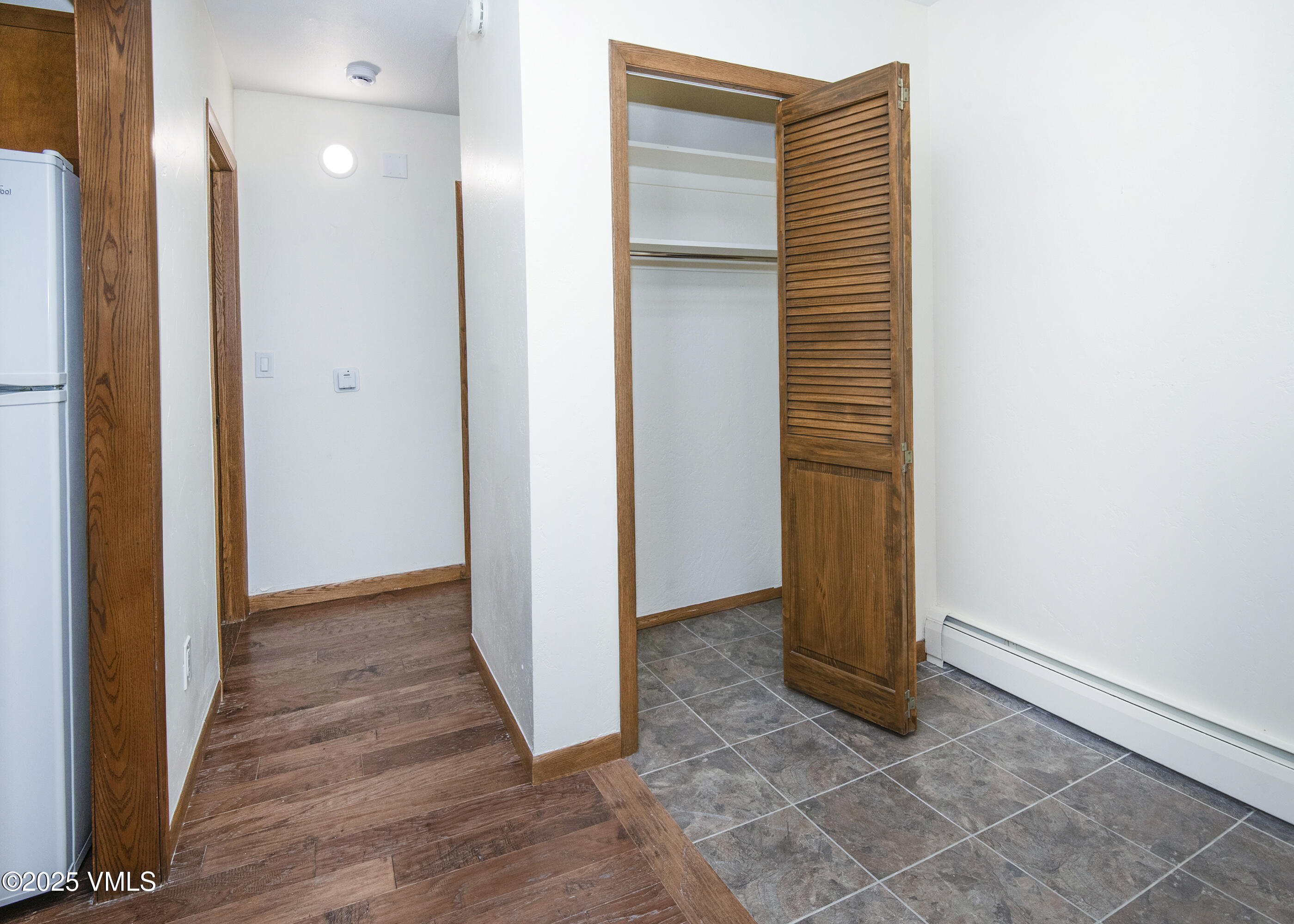 921 Red Sandstone Road, Unit A Vail, CO 81657 - Photo 15 of 26 an entryway with wooden floor and a bathroom