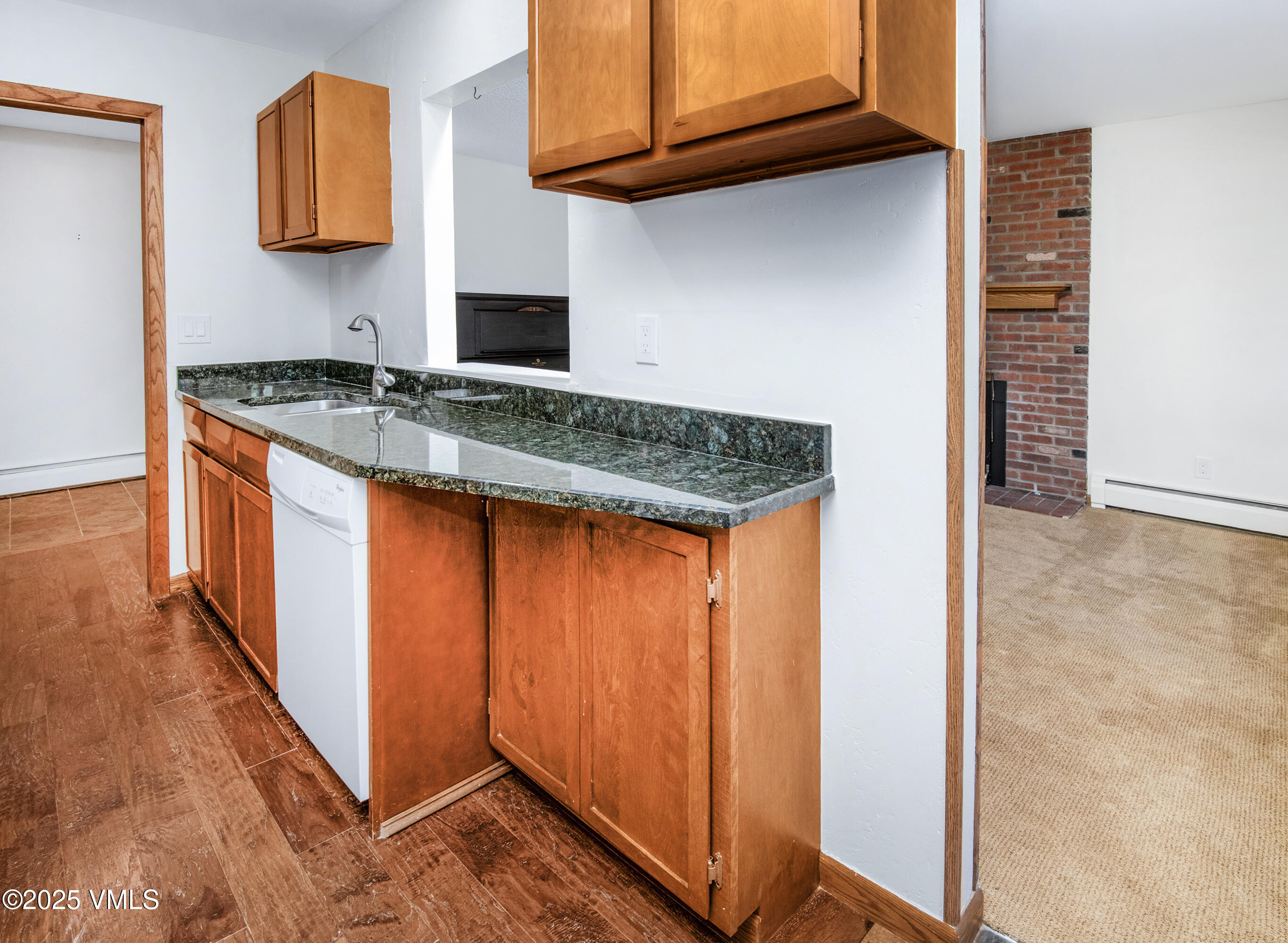921 Red Sandstone Road, Unit A Vail, CO 81657 - Photo 2 of 26 a kitchen with stainless steel appliances granite countertop a sink and a refrigerator