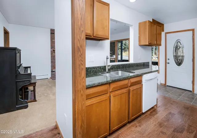 a kitchen with granite countertop a sink and a stove top oven
