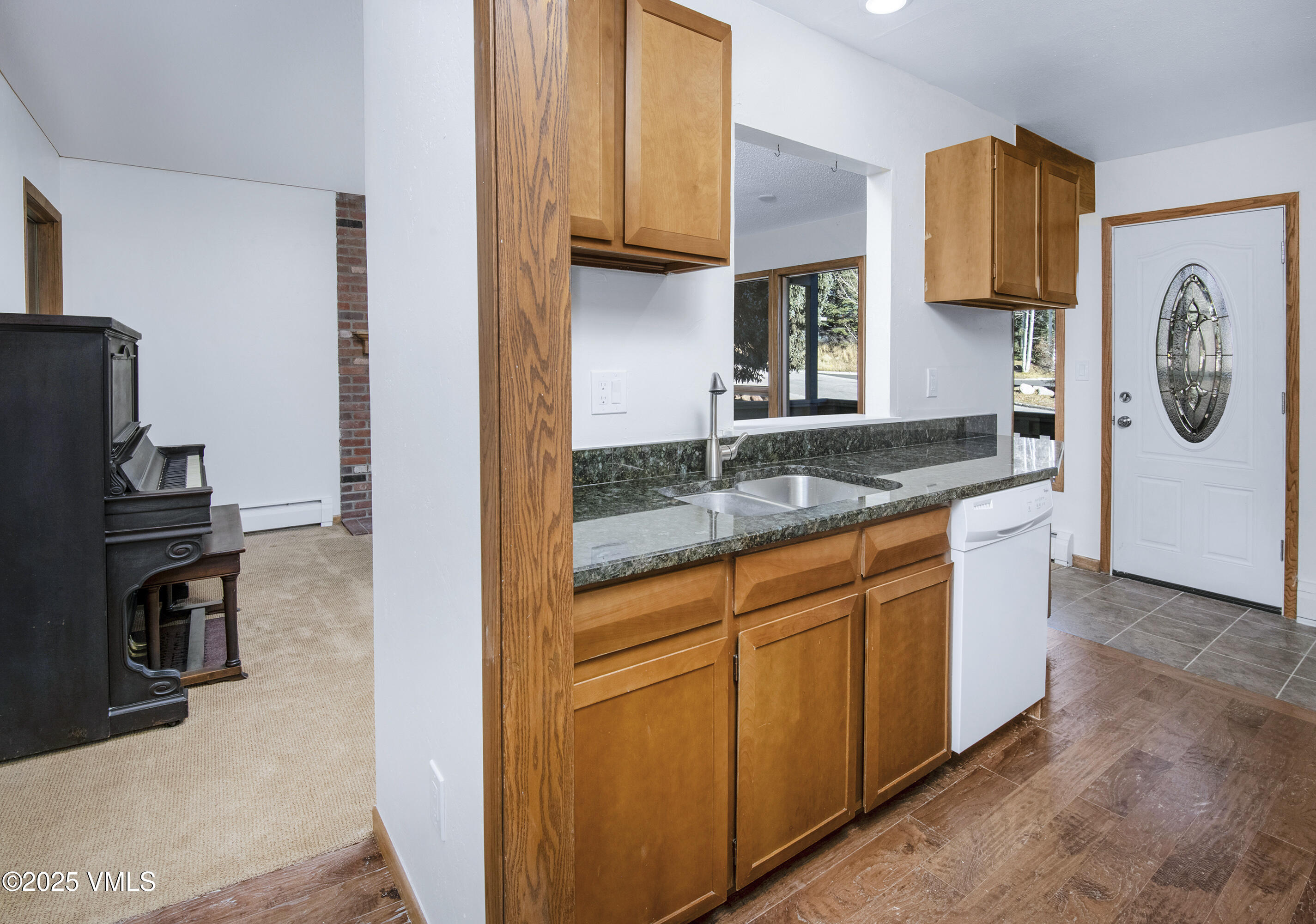 921 Red Sandstone Road, Unit A Vail, CO 81657 - Photo 4 of 26 a kitchen with granite countertop a sink and a stove top oven