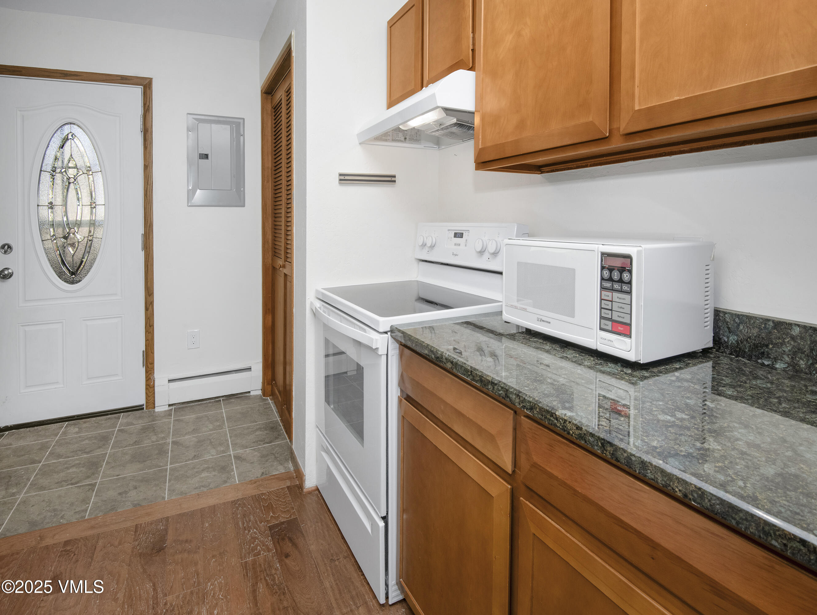 921 Red Sandstone Road, Unit A Vail, CO 81657 - Photo 6 of 26 a kitchen with granite countertop a sink and a stove