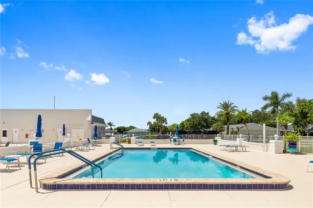 a view of swimming pool with outdoor seating and plants