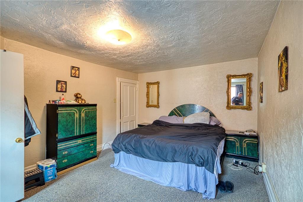 310 Campbell Street McKees Rocks, PA 15136 - Photo 8 of 13 a bedroom with a bed and a dresser