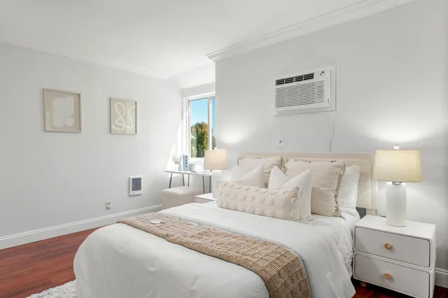 a bedroom with a bed and a night stand