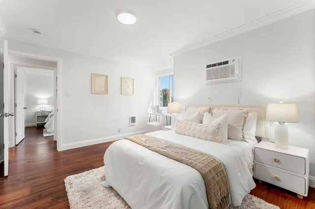 a spacious bedroom with a bed and a couch