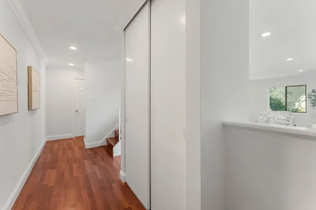 a view of hallway with wooden floor