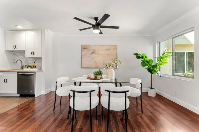 a view of a dining room with furniture and a potted plant
