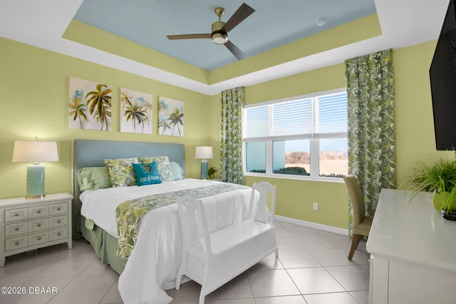 a bedroom with a bed a dresser and a window