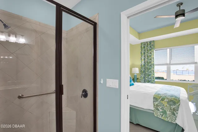 a living room with furniture and a floor to ceiling window