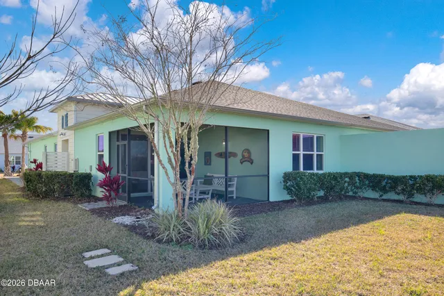 an aerial view of a house with swimming pool and sitting area