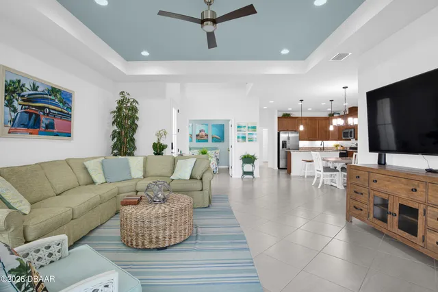 a kitchen with stainless steel appliances granite countertop a refrigerator a sink a stove with wooden cabinets