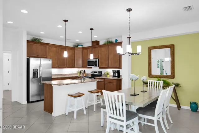 a kitchen with a sink a counter space appliances and cabinets
