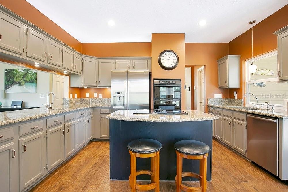 2702 Carter Grove Circle Windermere, FL 34786 - Photo 15 of 42 a kitchen with stainless steel appliances granite countertop a stove a sink and a refrigerator