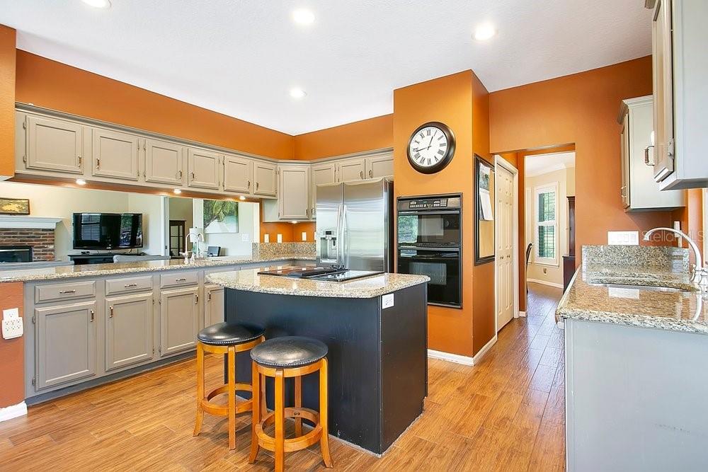 2702 Carter Grove Circle Windermere, FL 34786 - Photo 16 of 42 a kitchen with cabinets and wooden floor