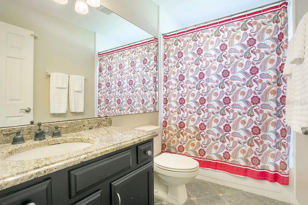 2702 Carter Grove Circle Windermere, FL 34786 - Photo 24 of 42 a bathroom with a granite countertop sink and a toilet