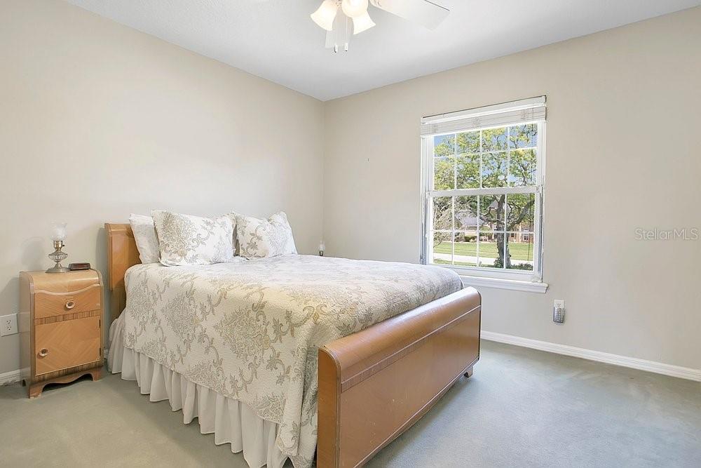2702 Carter Grove Circle Windermere, FL 34786 - Photo 26 of 42 a spacious bedroom with a bed and a chandelier fan