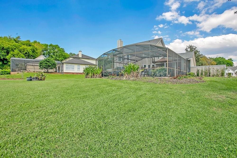 2702 Carter Grove Circle Windermere, FL 34786 - Photo 32 of 42 a view of a big house with a big yard and potted plants