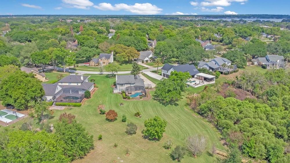 2702 Carter Grove Circle Windermere, FL 34786 - Photo 40 of 42 an aerial view of residential houses with outdoor space and trees