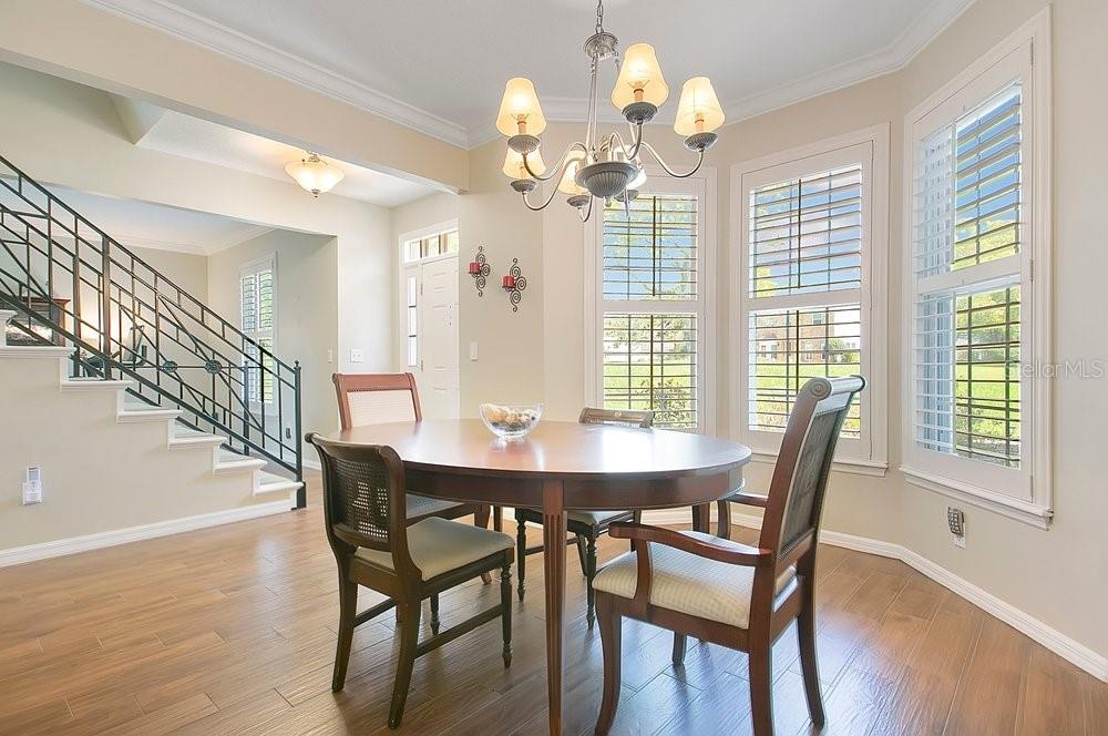 2702 Carter Grove Circle Windermere, FL 34786 - Photo 10 of 42 a view of a dining room with furniture a chandelier and wooden floor