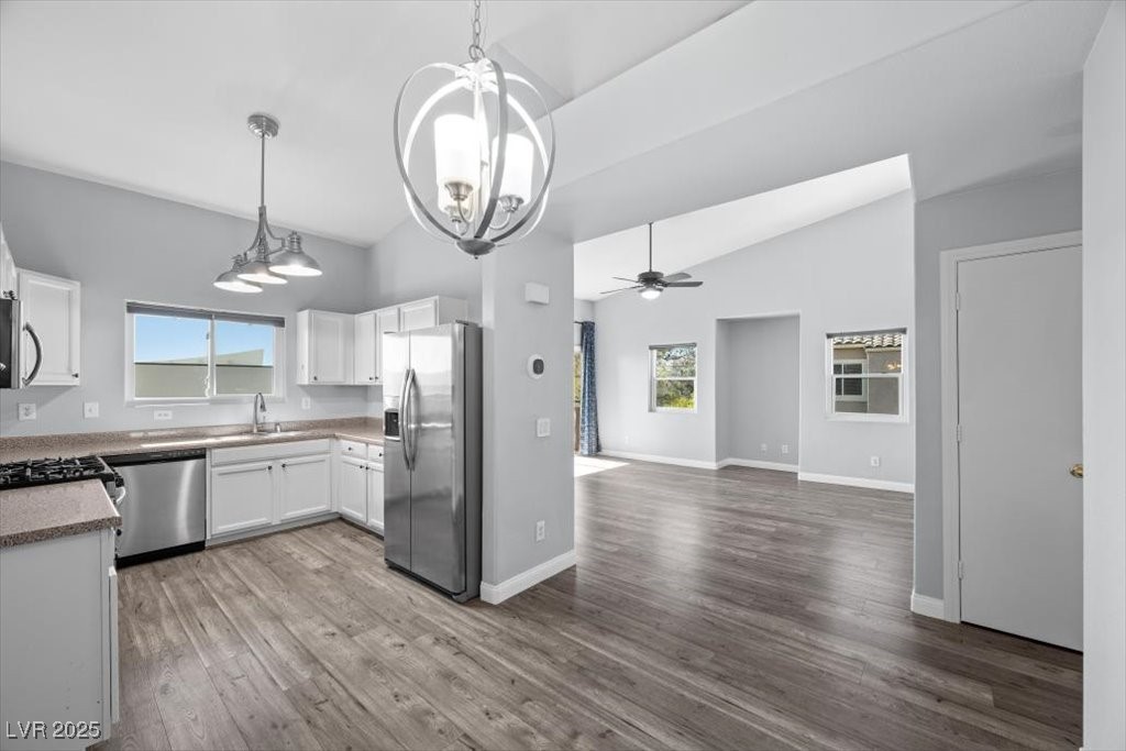 2152 Quarry Ridge Street, Unit 207 Las Vegas, NV 89117 - Photo 37 of 37 Dining Area/ Kitchen featuring appliances with stainless steel finishes, white cabinetry, open floor plan, pendant lighting, and a ceiling fan