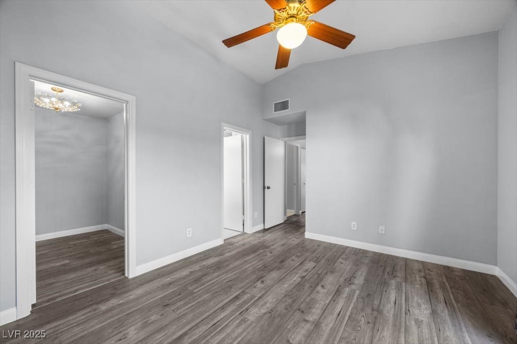 2152 Quarry Ridge Street, Unit 207 Las Vegas, NV 89117 - Photo 18 of 37 Unfurnished bedroom with dark wood-style flooring, ceiling fan, a spacious closet, and high vaulted ceiling