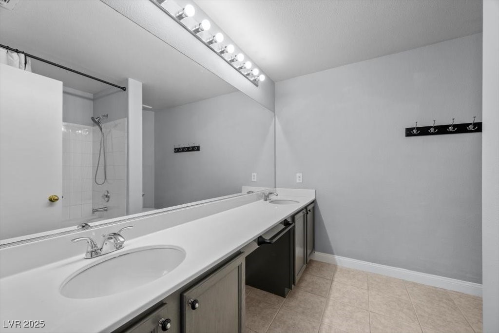 2152 Quarry Ridge Street, Unit 207 Las Vegas, NV 89117 - Photo 23 of 37 Full bath featuring double vanity, washtub / shower combination, and light tile patterned flooring