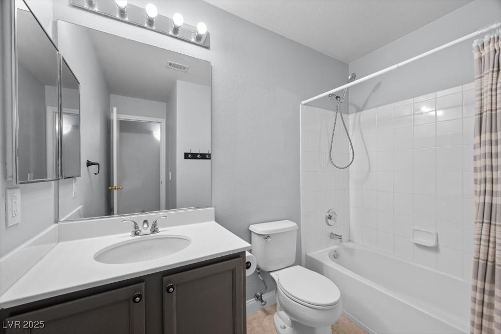 2152 Quarry Ridge Street, Unit 207 Las Vegas, NV 89117 - Photo 28 of 37 Bathroom with shower / bath combo with shower curtain and vanity