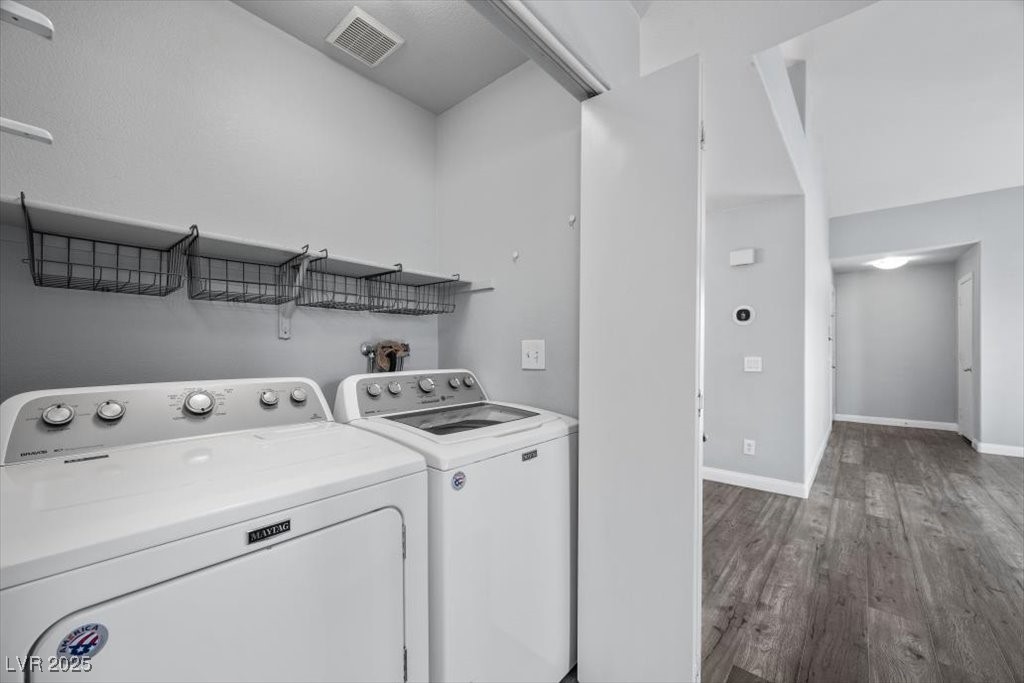 2152 Quarry Ridge Street, Unit 207 Las Vegas, NV 89117 - Photo 29 of 37 Washroom with wood finished floors and washer and clothes dryer