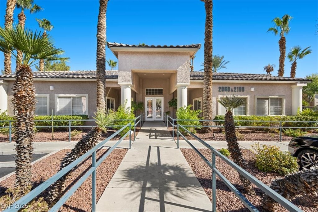 2152 Quarry Ridge Street, Unit 207 Las Vegas, NV 89117 - Photo 31 of 37 Community Clubhouse with french doors, stucco siding, and a tiled roof