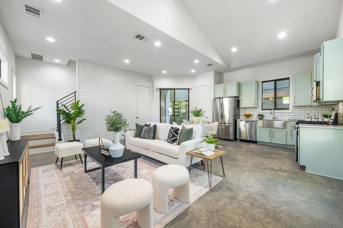 a living room with furniture and kitchen view
