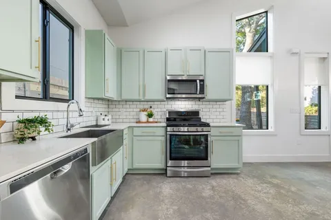 a kitchen with a sink stove and microwave