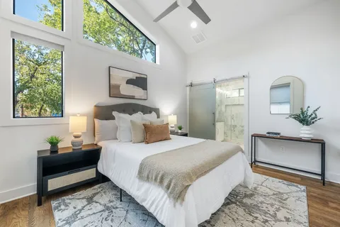 a bedroom with a bed and a potted plant