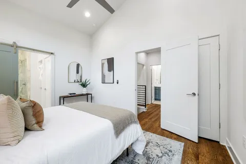 a bedroom with a bed and wooden floor