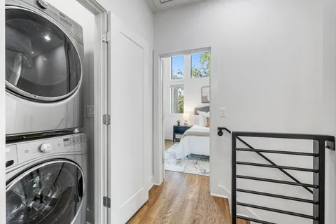 a view of a hallway with washer and dryer