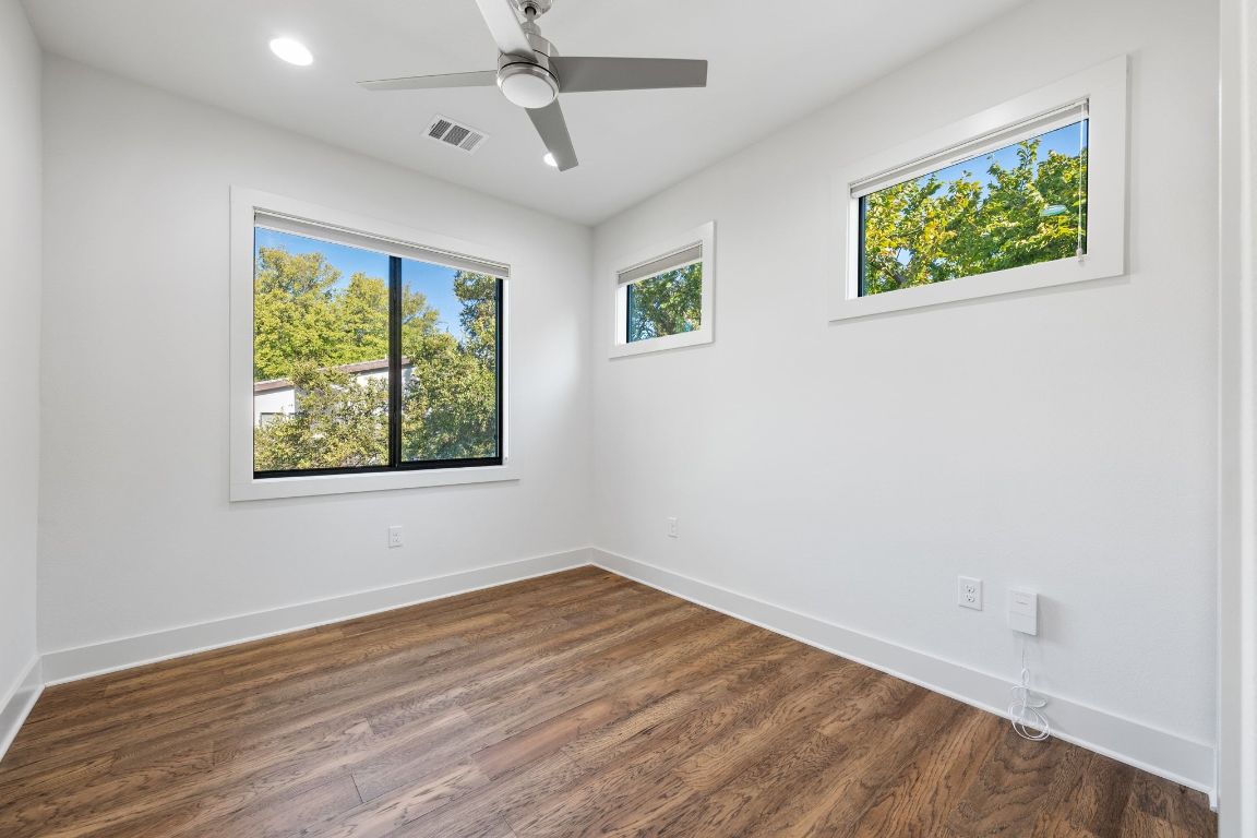 1118 Algarita Avenue, Unit 1 Austin, TX 78704 - Photo 18 of 26 a view of an empty room with wooden floor and window