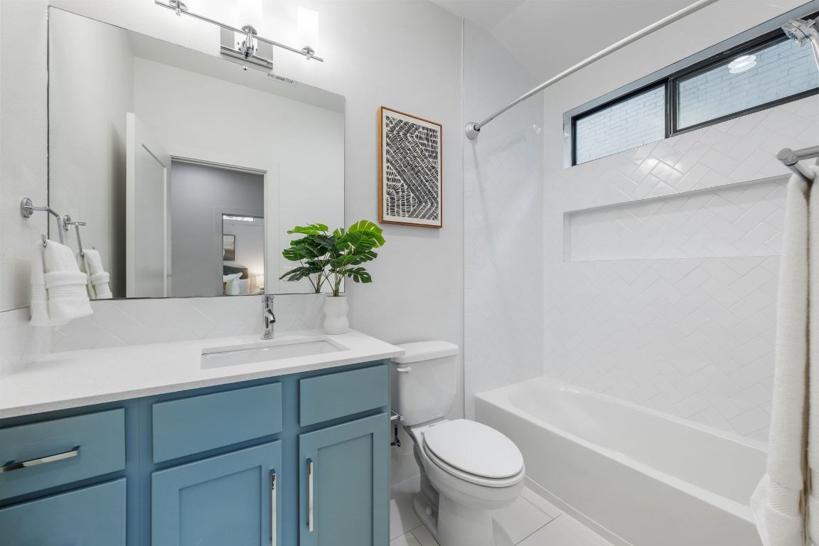 1118 Algarita Avenue, Unit 1 Austin, TX 78704 - Photo 19 of 26 a bathroom with a sink a toilet and shower