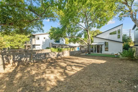 a view of a house with a yard and tree s
