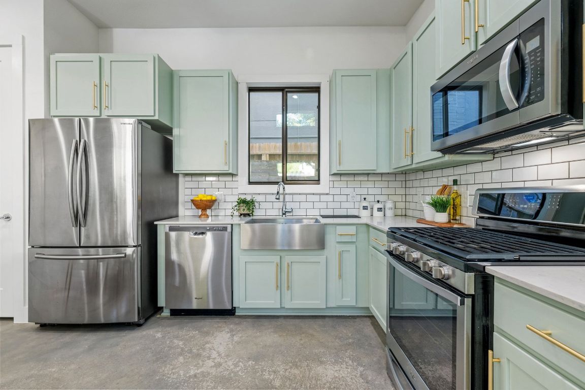 1118 Algarita Avenue, Unit 1 Austin, TX 78704 - Photo 10 of 26 a kitchen with stainless steel appliances granite countertop a refrigerator a stove a sink and a microwave