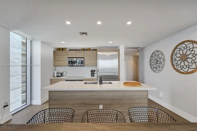 a living room with furniture large windows and a flat screen tv