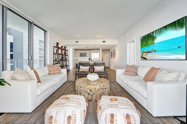 a bedroom with furniture and a large window