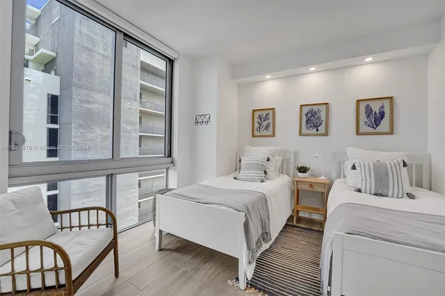 a bedroom with a bed and a lamp