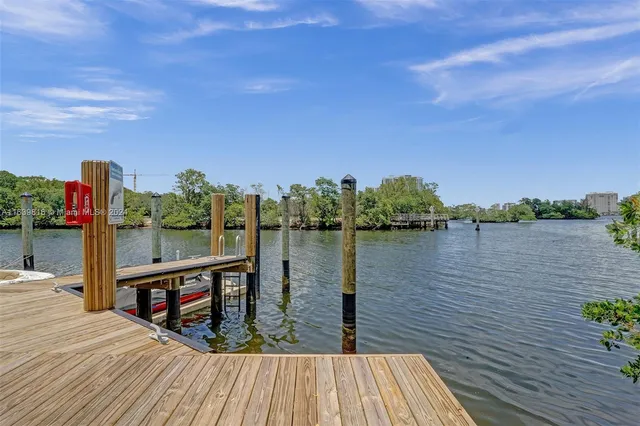 a view of a lake with tables and chairs