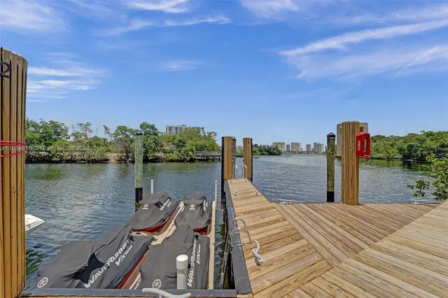 a view of a balcony with wooden floor and outdoor seating