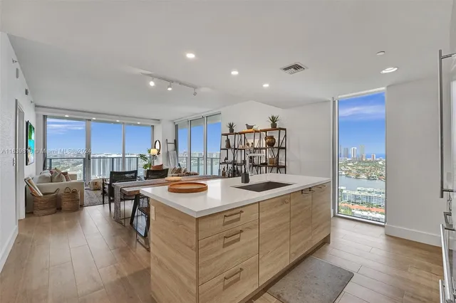 a kitchen with stainless steel appliances granite countertop a refrigerator and a sink