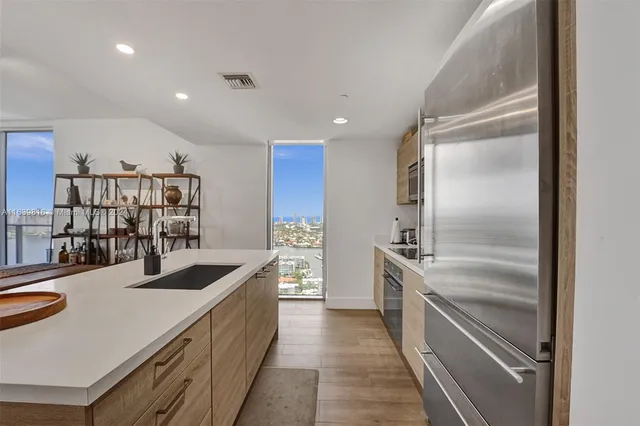 a kitchen with stainless steel appliances granite countertop a sink and cabinets