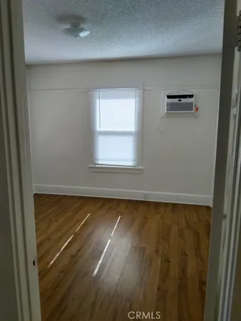 a view of a room with wooden floor and window